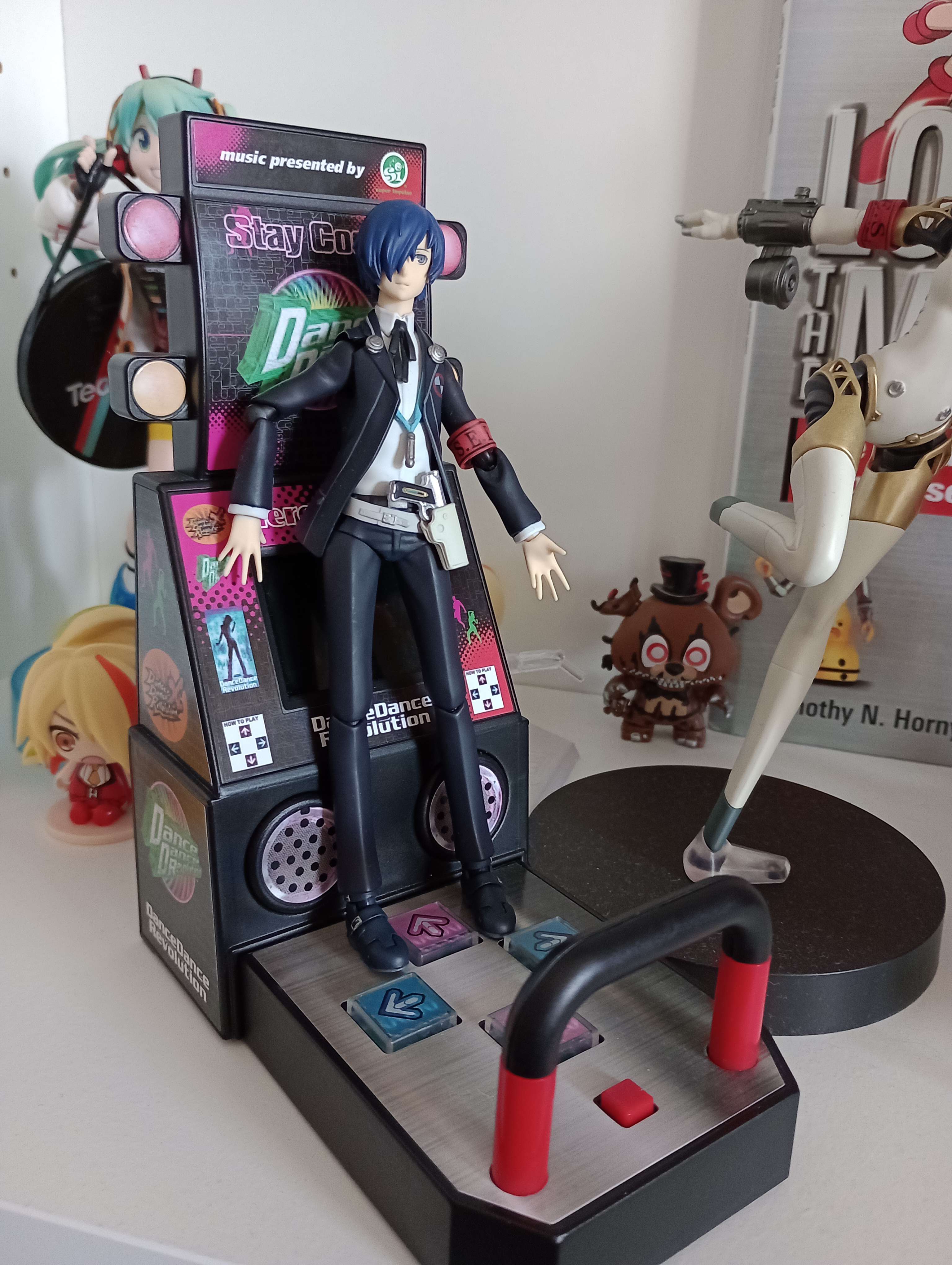 the DDR minicab with a posable anime figure leaning up against it.