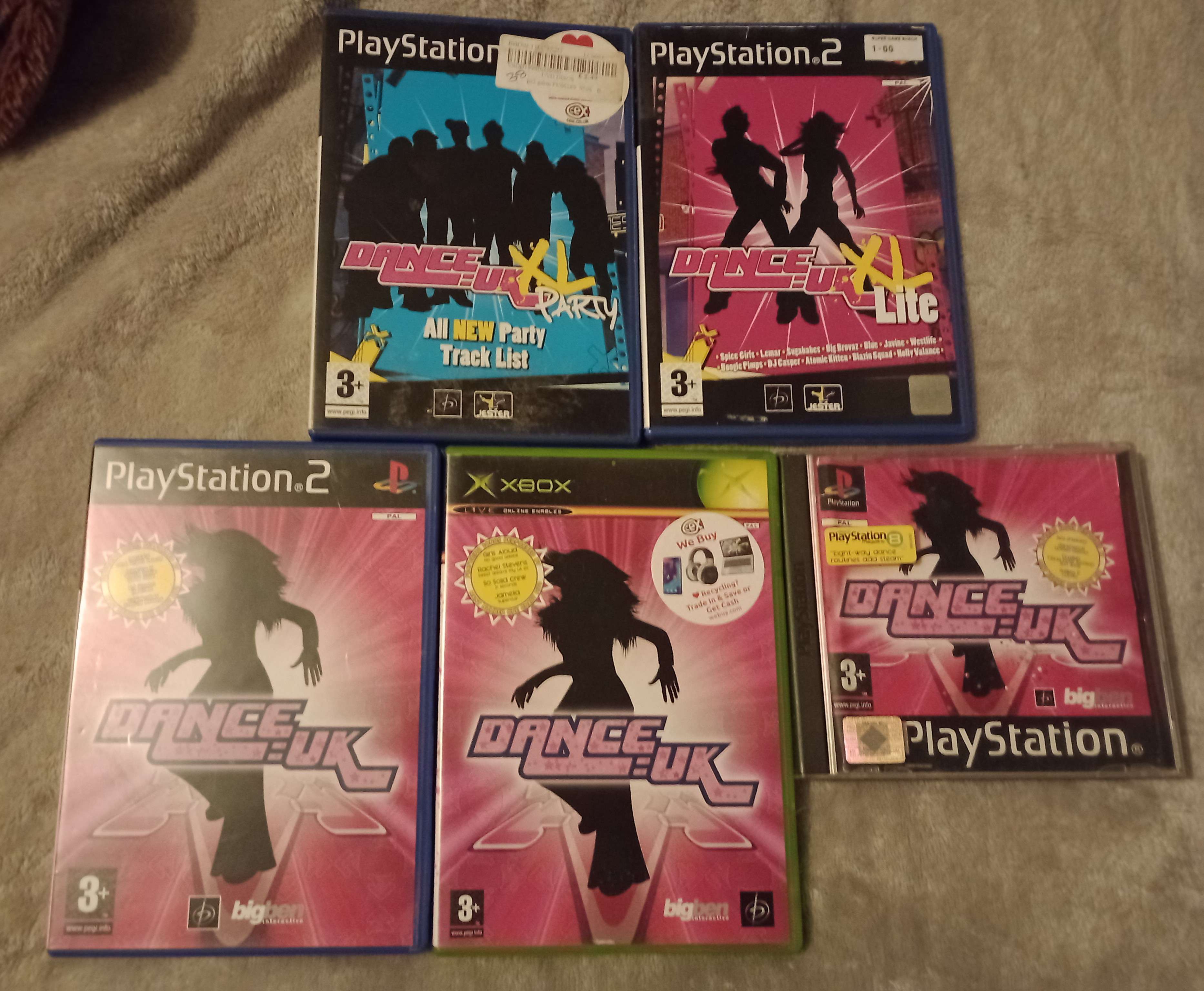 five of the DANCE:UK games laid out. DANCE:UK on the XBOX, PS2, and PS1, as well as DANCE:UK XL Lite and DANCE:UK XL Party for the PS2.