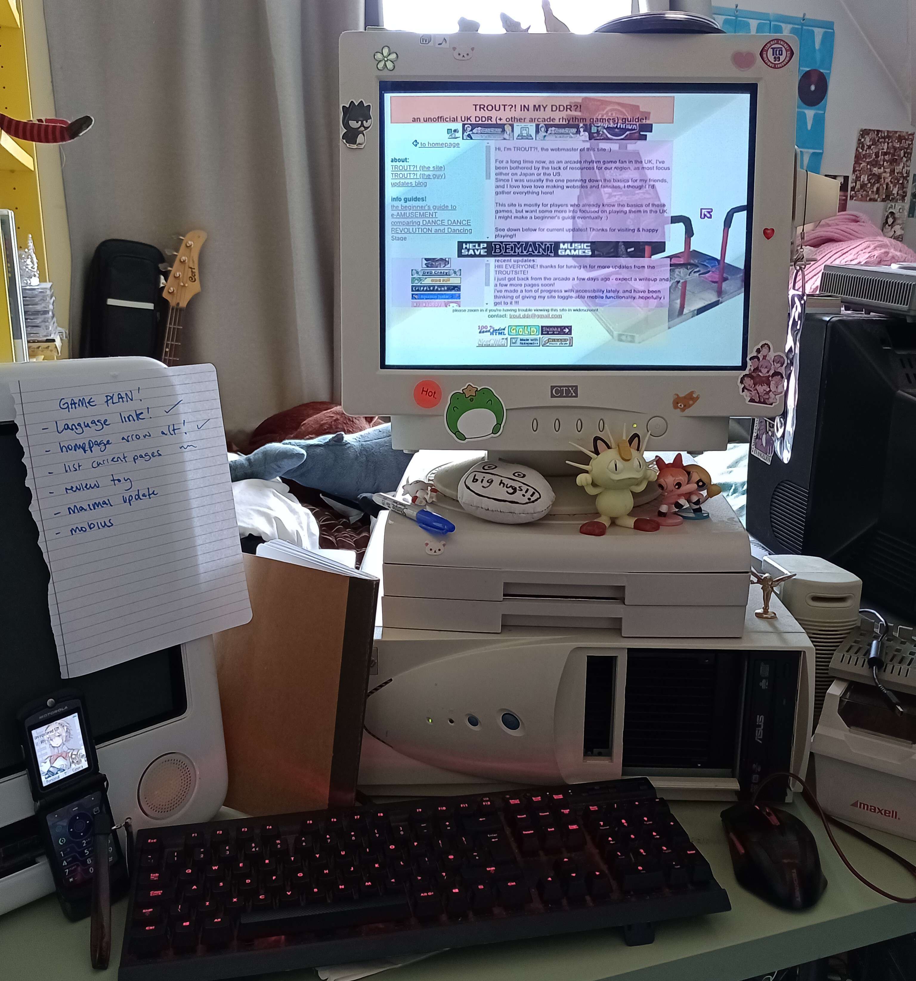 TROUT's computer setup with the square 4 by 3 screen, surrounded by toys and other junk.